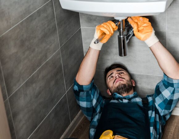 Handyman working on sink with commercial insurance in San Luis Obispo, CA 