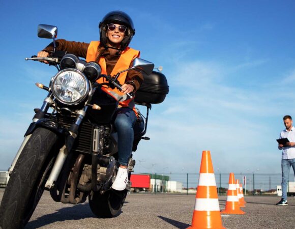 woman driving motorcycle between cones with Motorcycle Insurance in Santa Maria, CA