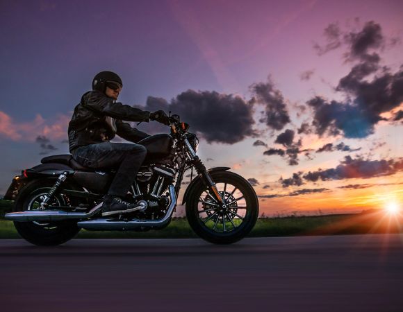 rider with motorcycle insurance driving on a road in Paso Robles, CA